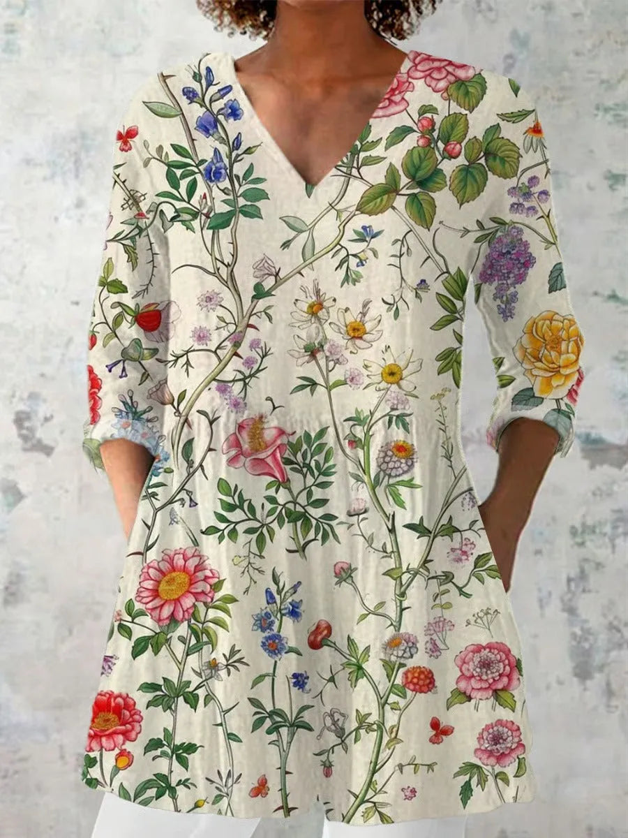 Woman wearing a retro slim fit, digitally printed long-sleeved top in a floral design.