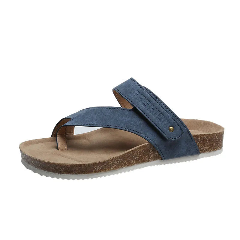A pair of flat toe ring thick-soled flip-flops in a solid colour on a plain background.
