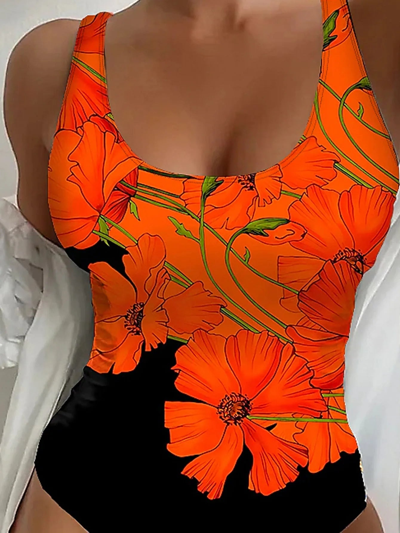 Women's orange flower print backless one-piece swimsuit on a mannequin, showing slim fit.