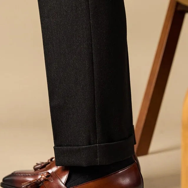 Men's black and brown tassel loafers with polished leather upper and rubber sole in British business casual style