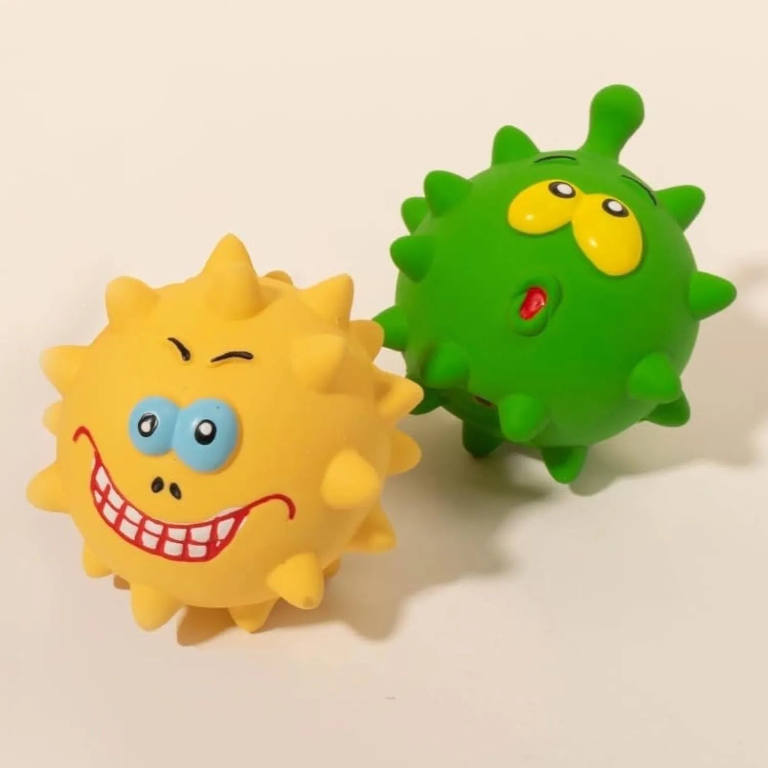Four colourful squeaky dog toys with cute faces made from natural latex rubber