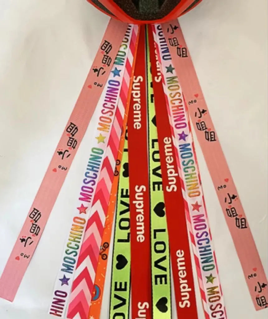 Close-up of a colourful decorative ribbon streamer attached to a child's helmet for roller skating or skiing.
