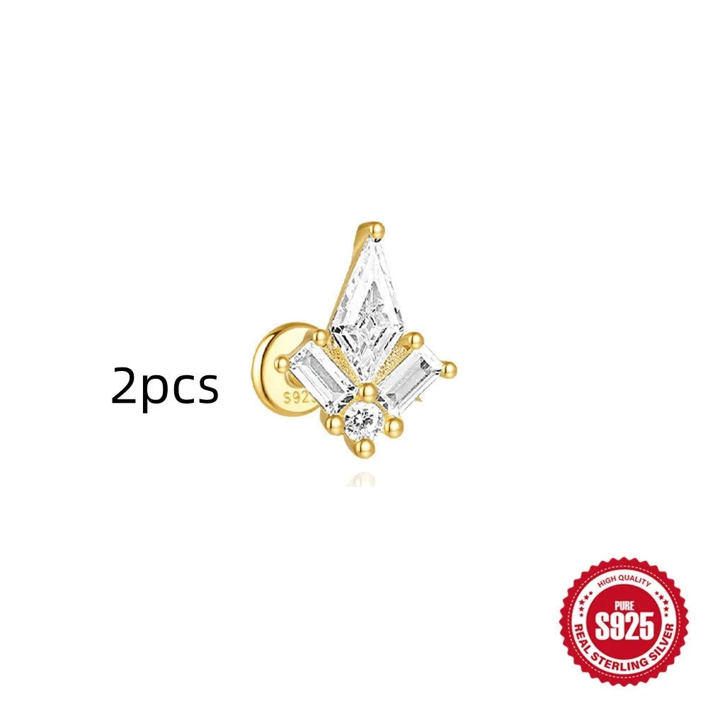 Geometric kite-shaped sterling silver earring with rhinestone head and gold chain tassel.
