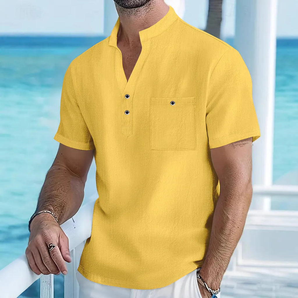 Man wearing a light blue linen-blend stand collar T-shirt with short sleeves and a loose fit.