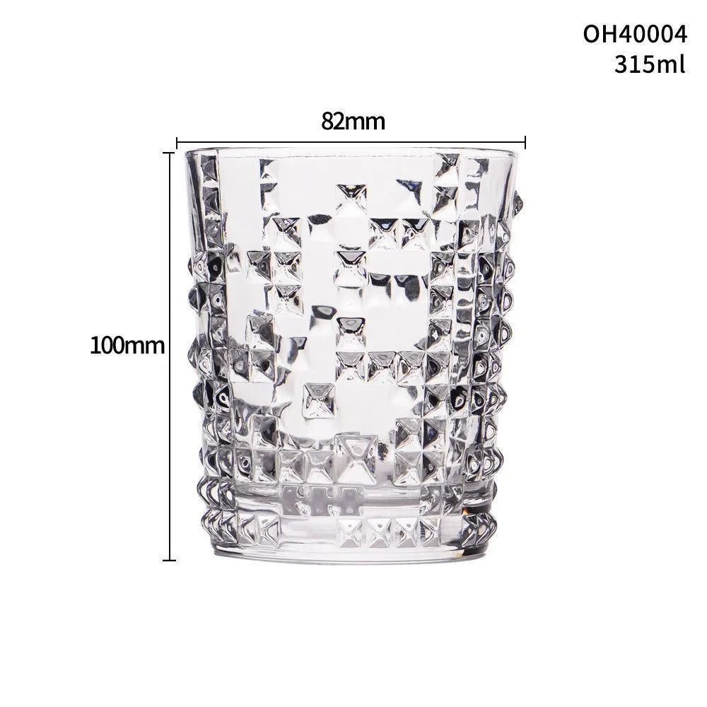 Clear thick-bottom whiskey shot glass with 301-400ml capacity on a table.