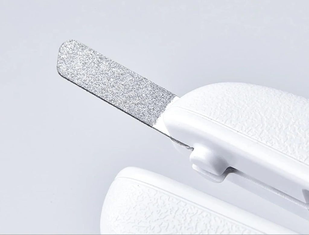 White pet nail clippers with LED light, transparent anti-splash baffle, and a nail file.