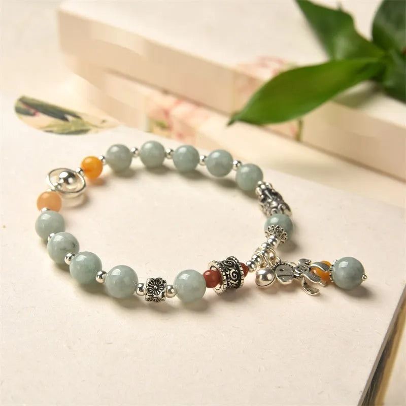 A vintage-style natural jade and alloy metal bracelet bangle for adults, showing retro pony style design.
