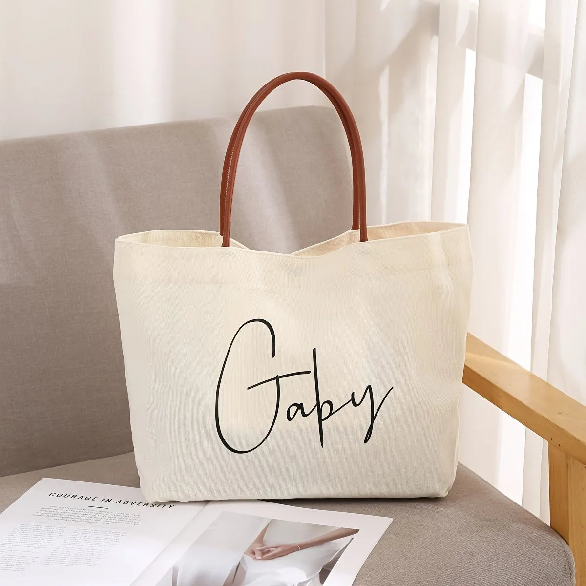 Heavyweight beige white canvas tote bag with reinforced handles on a plain background