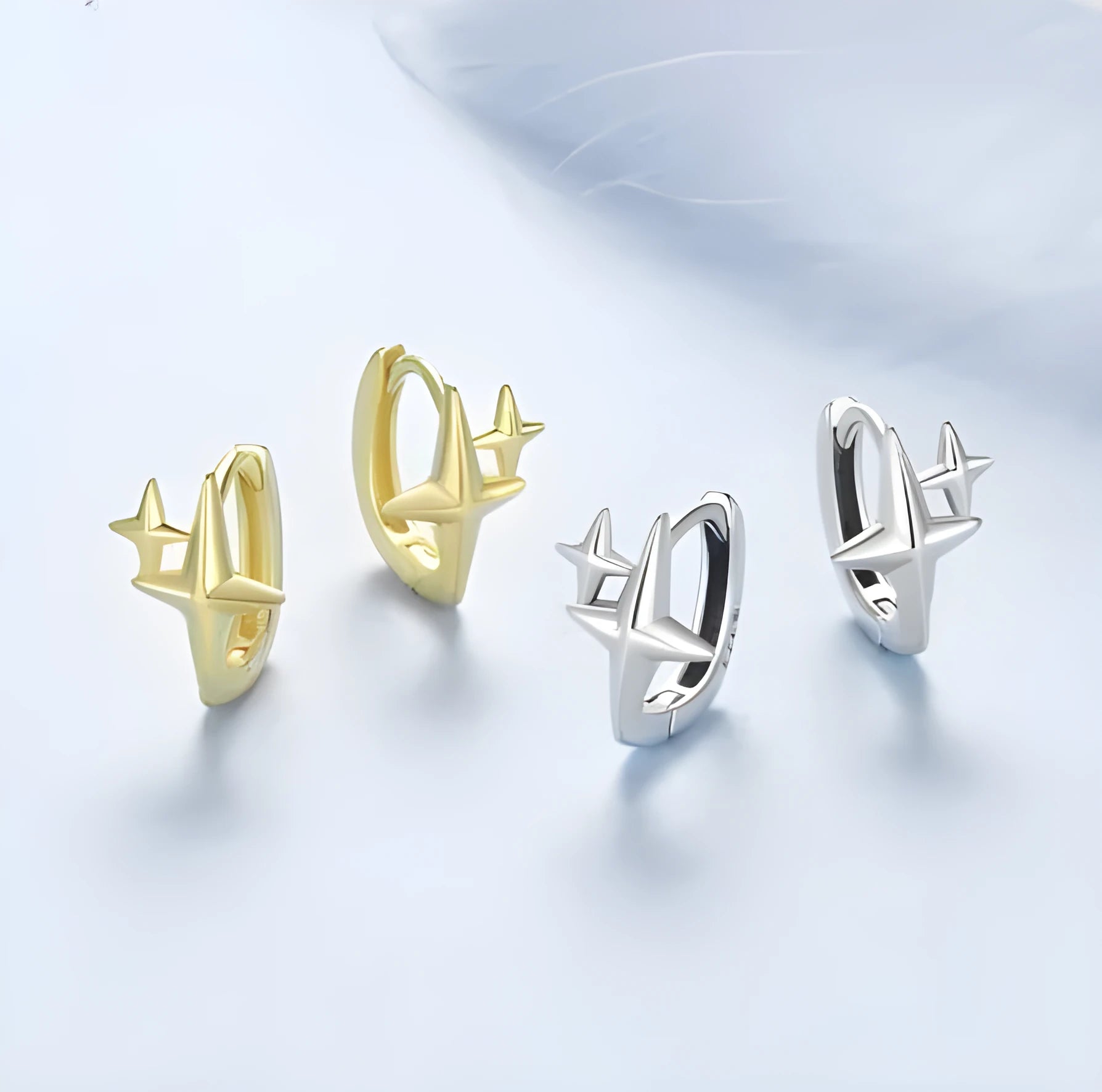 Minimalist star design ear clips in sterling silver with oxidised finish and XINGX elements