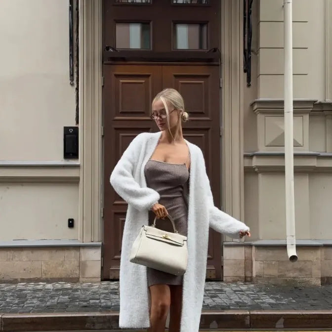 White women's longline cardigan jacket with long sleeves, loose fit.