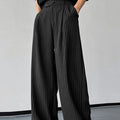 Men's black vertical striped pleated casual trousers showing front view