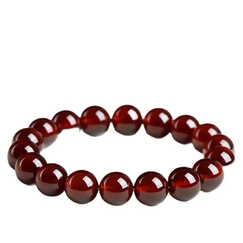 Natural orange red garnet ball bracelet with crystal beads showing ruyi pattern detailing