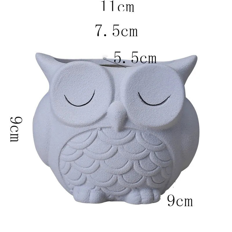 Handmade frosted ceramic flower pot with cartoon owl design, shown in light pink colour.