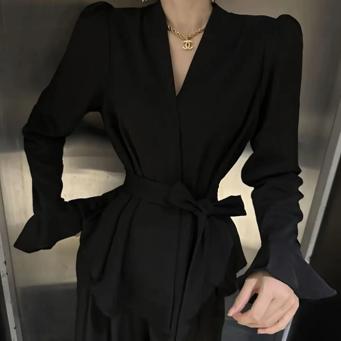 Women's French-style irregular collar shirt with long bell sleeves and tie front detail in polyester fabric.