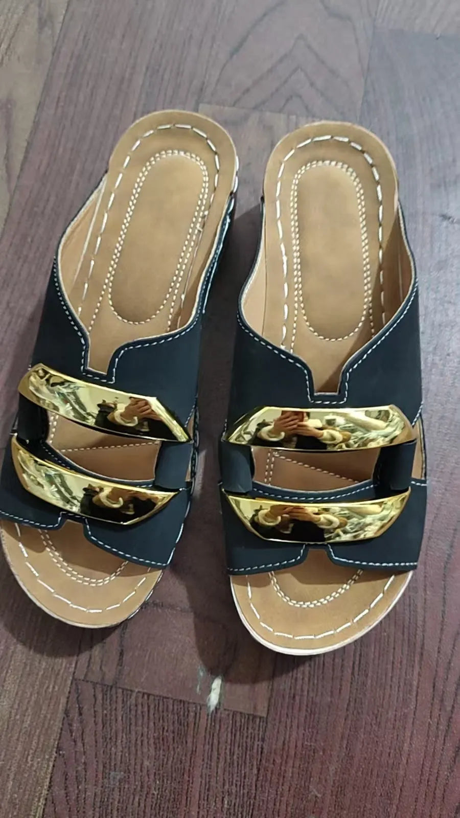 White Roman style platform sandals with flat heel and metal detail on a rubber sole.