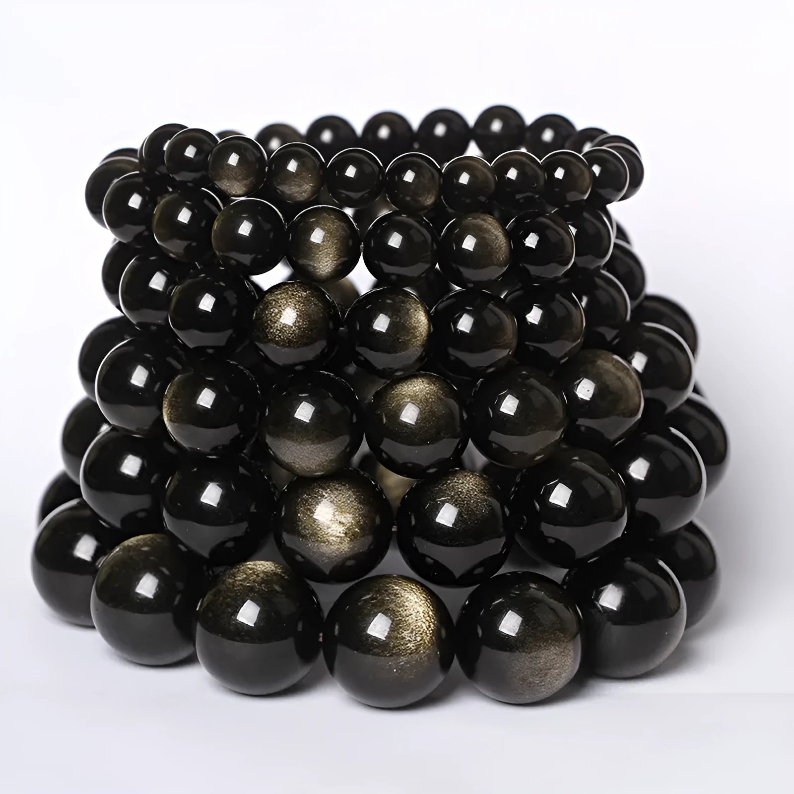 Hand-woven obsidian couple bracelet showing spherical black crystal beads in continuous strand construction