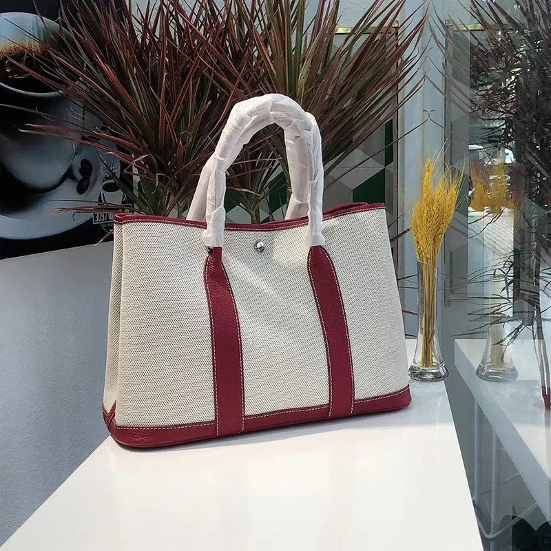 Women's canvas crossbody shoulder tote bag with leather detailing and bucket shape