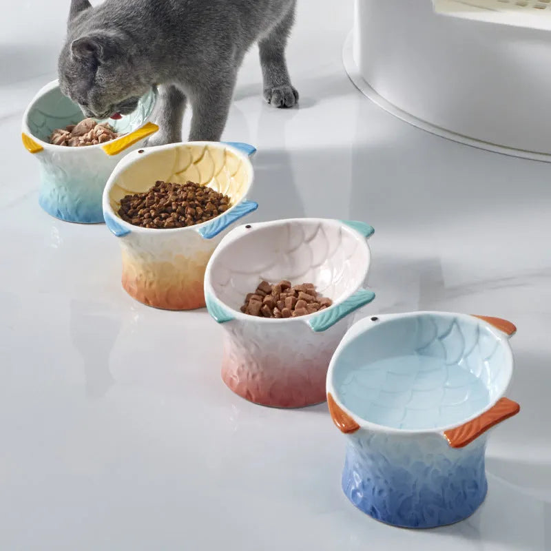 Set of blue ceramic cat feeder bowls in a fish shape with a 15-degree tilt angle.