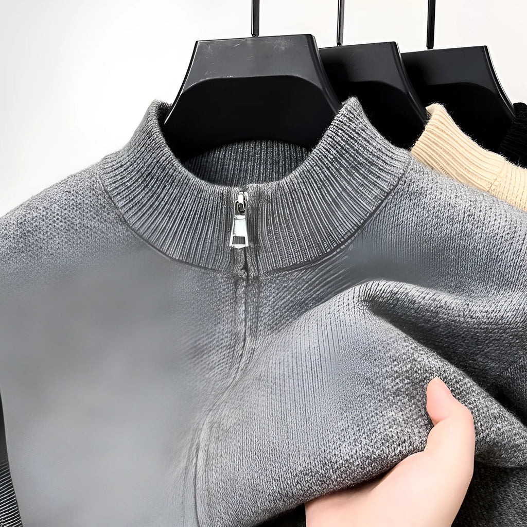 Man wearing a beige high collar zip-front knit cardigan, loose fit, long sleeves.