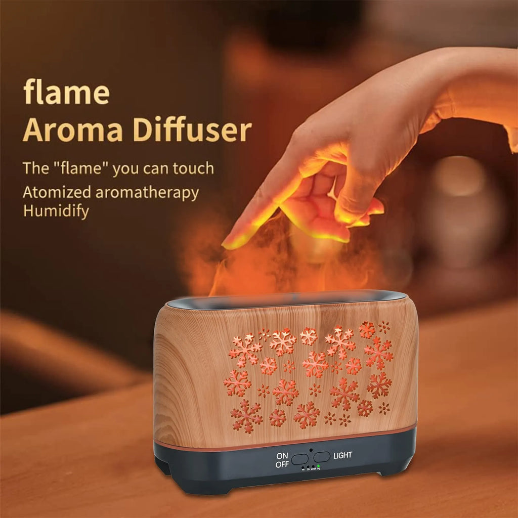 Colourful snowflake pattern aromatherapy humidifier with glowing flame effect and remote control on a desktop.