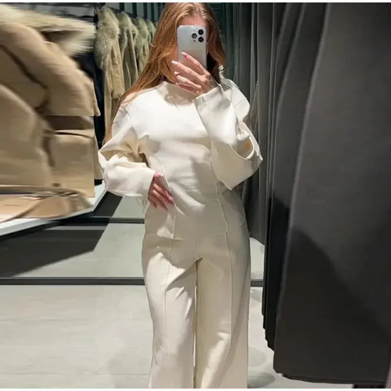 Women's apricot polar fleece suit set with long sleeve top and wide leg trousers on a hanger.