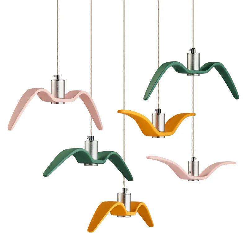 Nordic style ceiling chandelier with macaron colour options shown in a dining room setting.