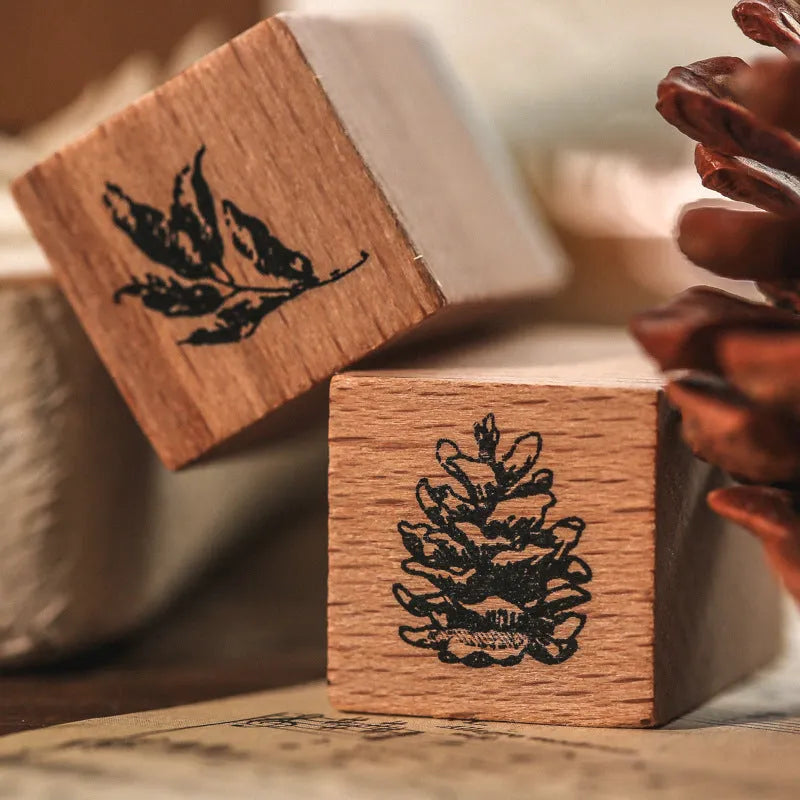 Wooden decorative seal stamp set with seven pieces showing botanical or celestial designs in mixed sizes