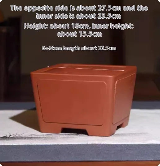 A square purple clay flower pot for succulents or bonsai plants on a tabletop.