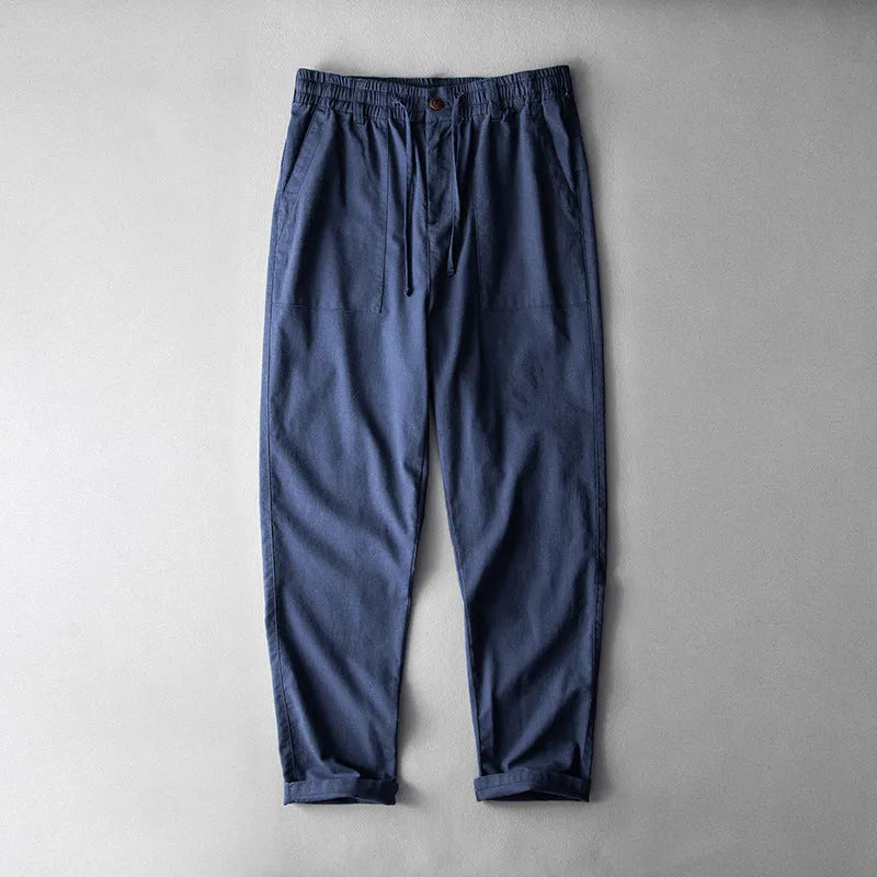 Men's mid waist linen trousers in solid colours showing trousers length and casual styling