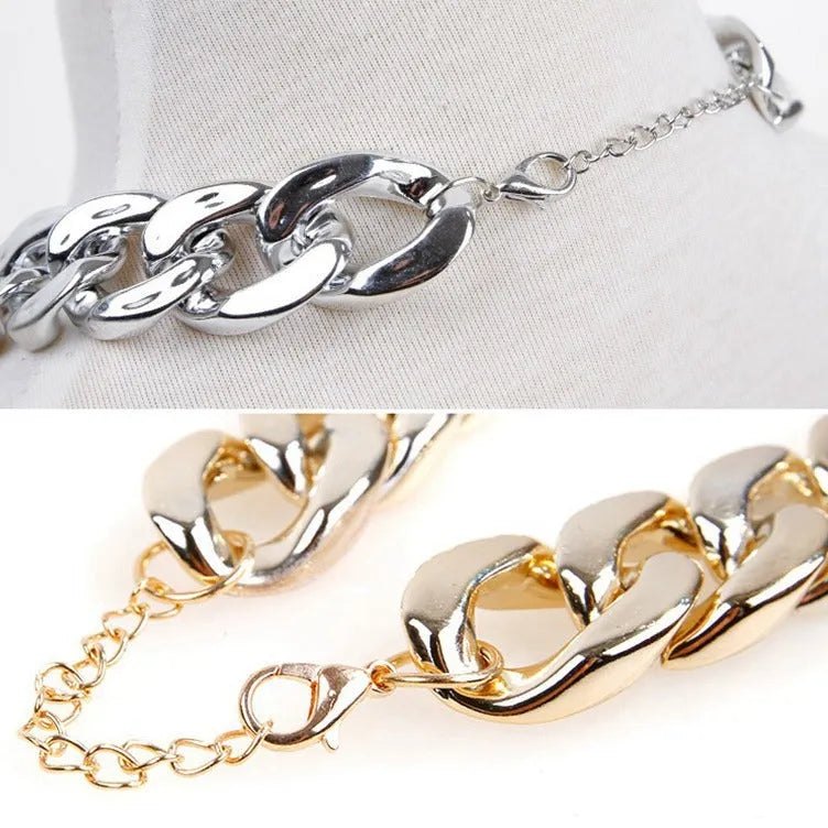 Gold geometric buckle dog chain collar on a small dog, showing twisted link design.