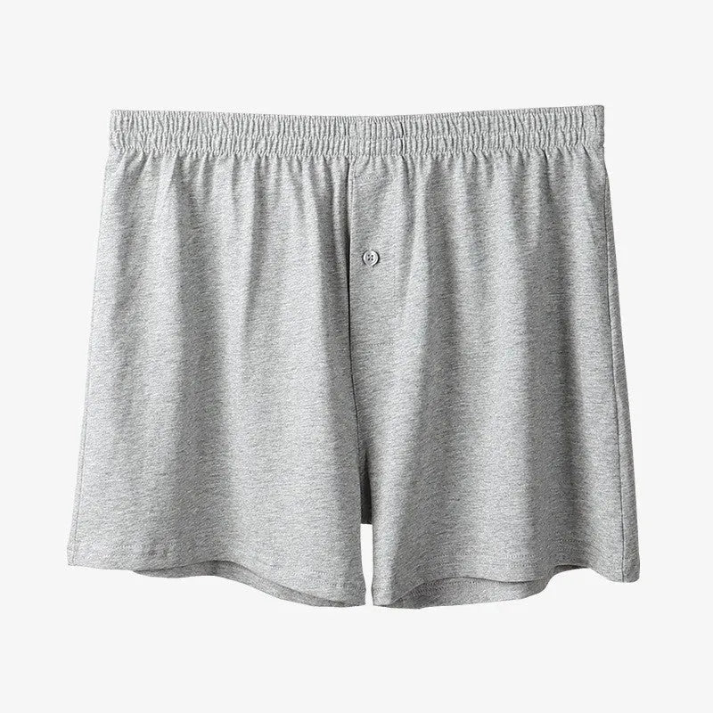 Men's solid-colour cotton boxer shorts with a high-waist, loose fit on a neutral background.