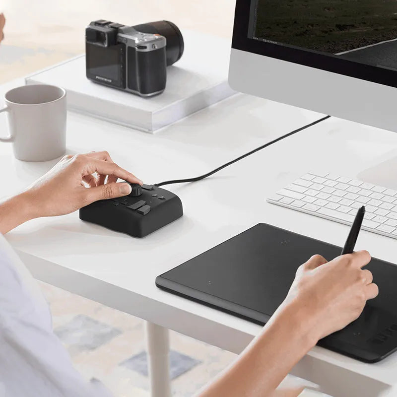 TourBox NEO auxiliary keyboard controller for digital video editing with black plastic housing