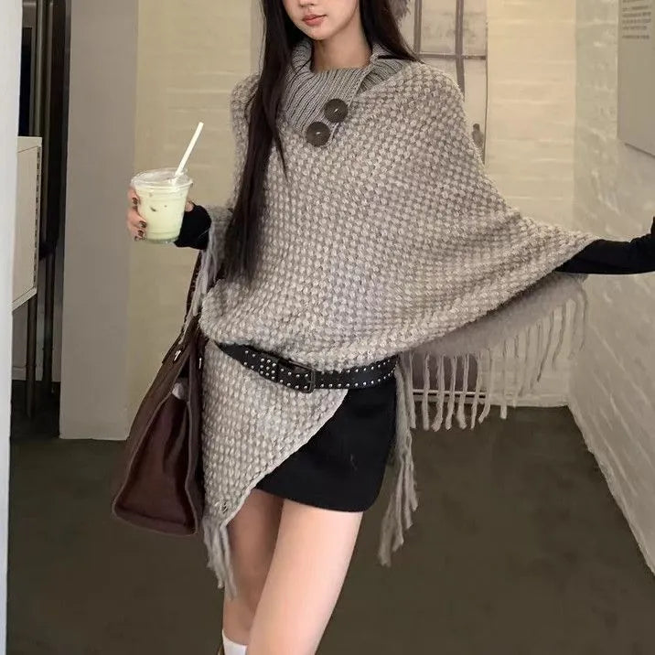 Women's casual plush triangle shawl cape with tassel details in a cashmere and acrylic fabric blend.