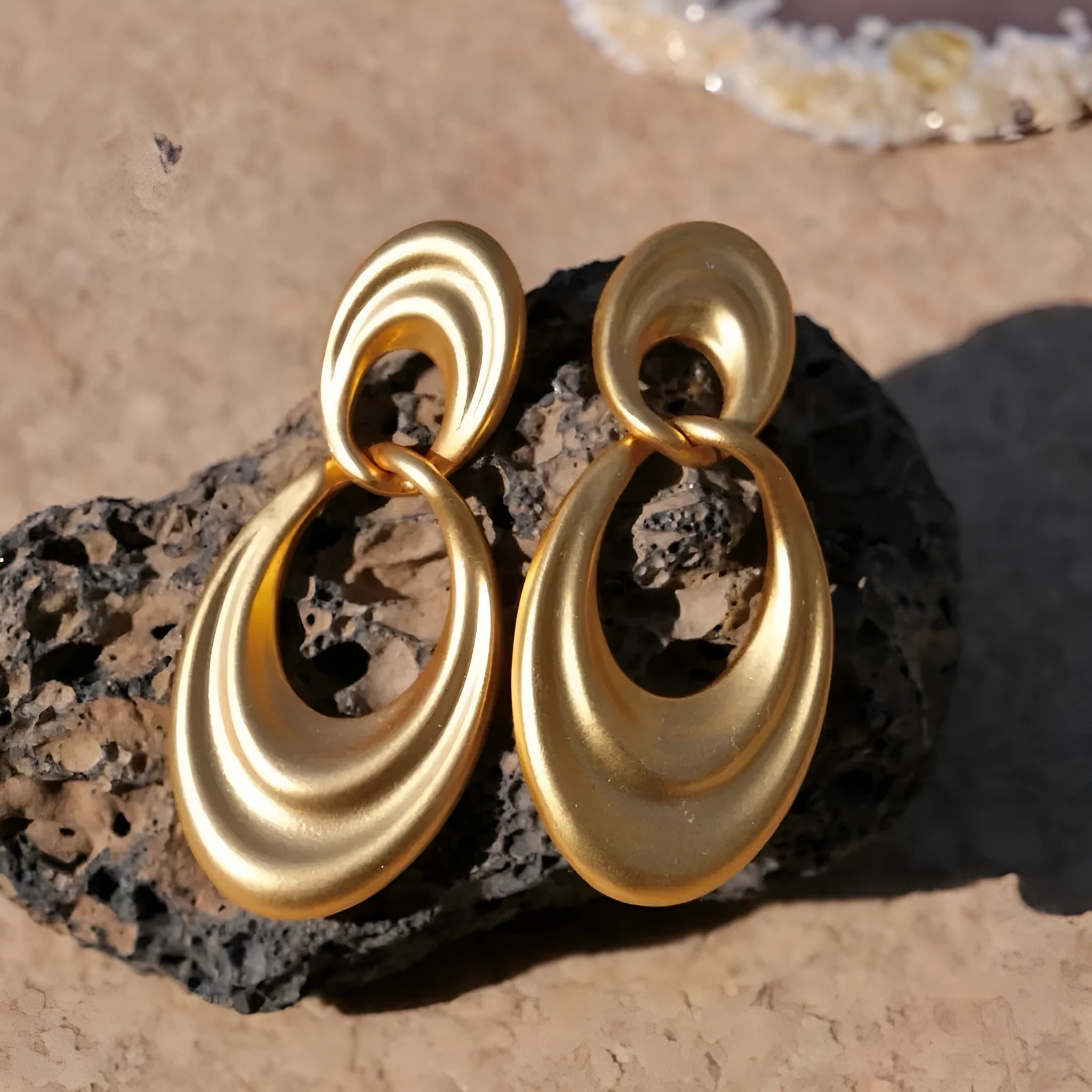 Quicksand gold coloured double circle French retro drop earrings with a U-shaped silhouette.
