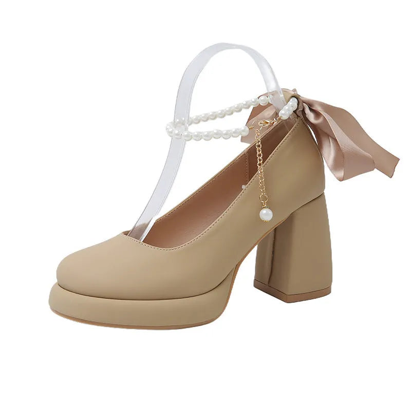 Women's beige Mary Jane shoes with chunky heel and ankle-strap buckle on a white background