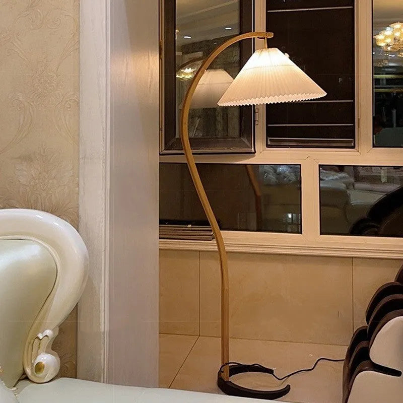 Retro vertical table lamp with tall stand and choice of log white or wine red shade on a bedside table.