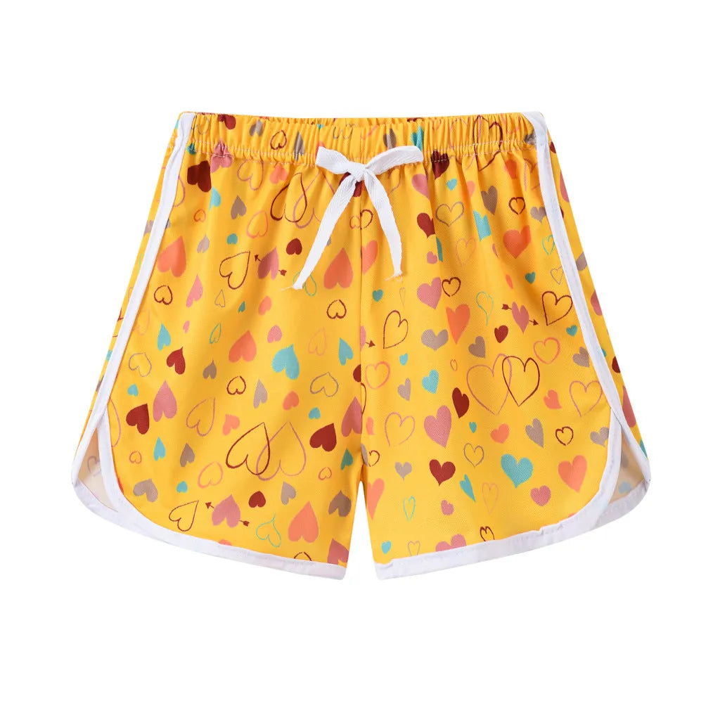 Children's polyester beach shorts in various colours and patterns including stripes, prints and solid options