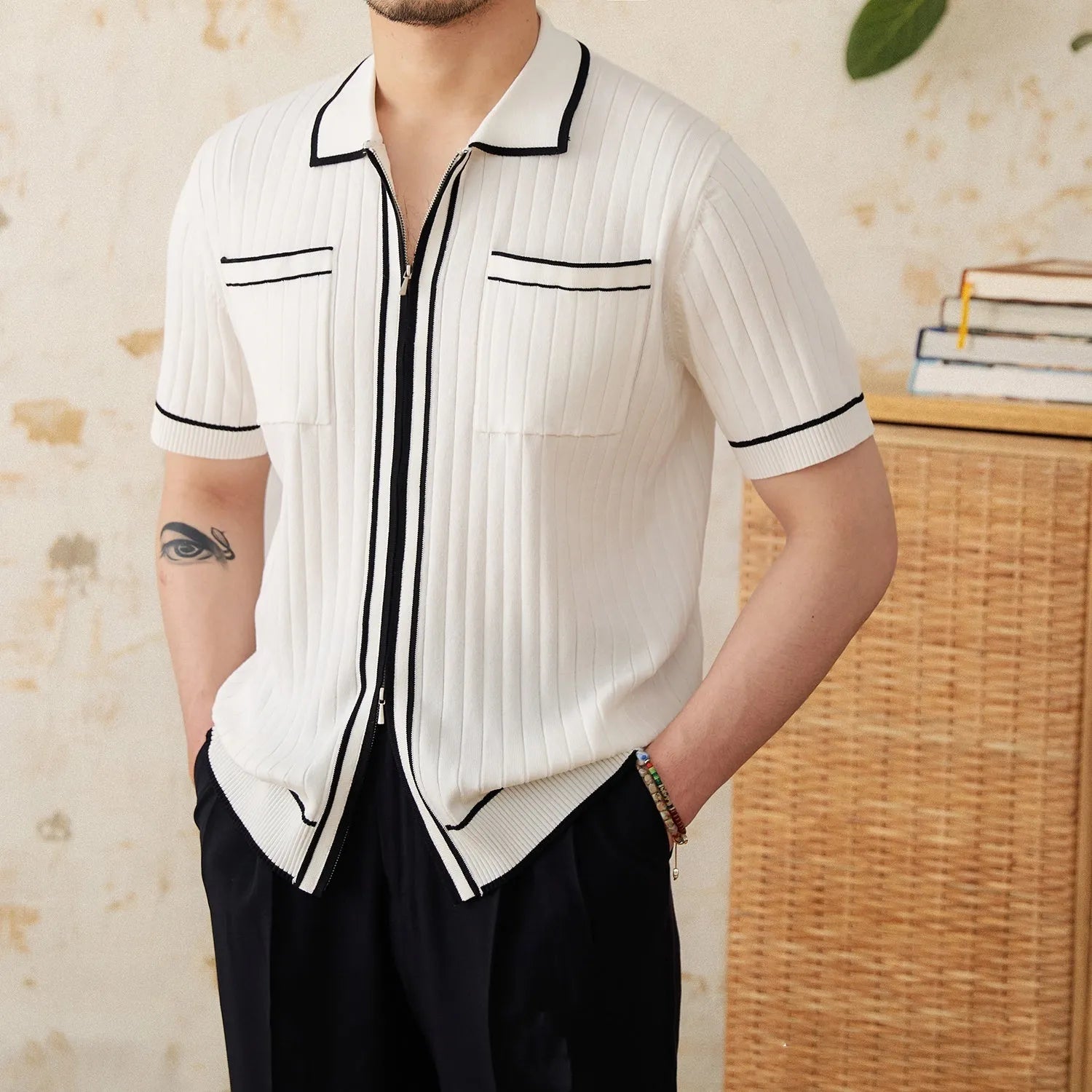 Slim fit black polo shirt with short sleeves and a lapel collar on a mannequin.