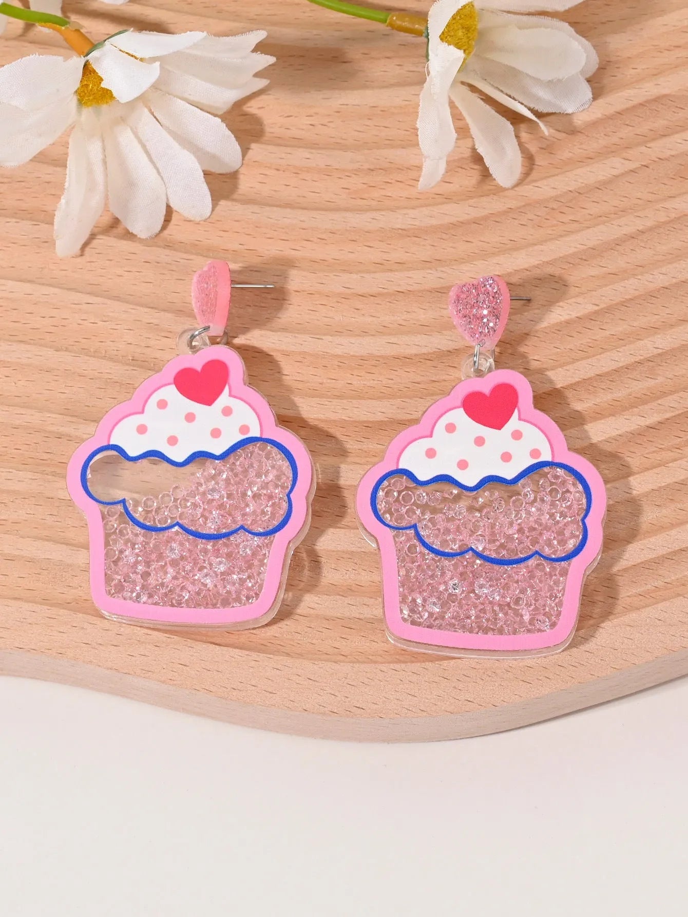 Colourful acrylic novelty earrings shaped like fruits and desserts including cherry, strawberry, and ice cream.