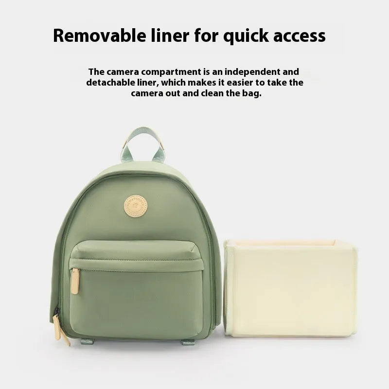 Women's polyester shoulder camera bag in black with a curved strap and detachable iPad pocket.