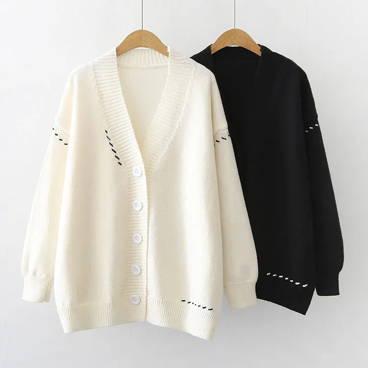 Women's loose fit black knitted cardigan coat with long sleeves.