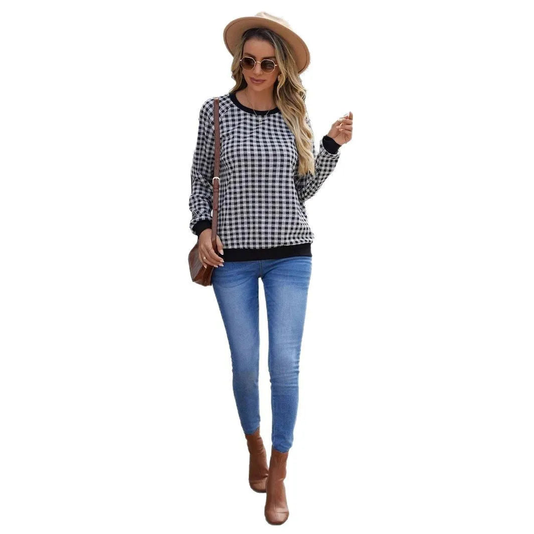 Black long sleeve pullover sweater with a striped plaid pattern and printed design detail.