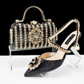 Women's black synthetic leather high-heel shoes with rhinestone ankle chain and matching hard clutch bag.