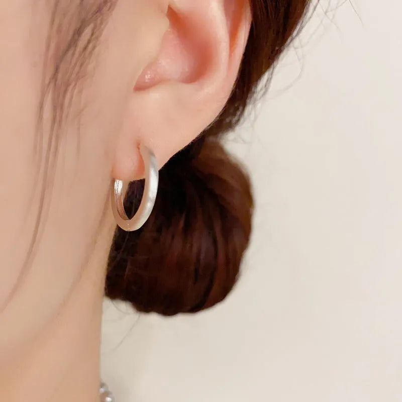Geometric women's ear clips with gold plating and round eyelet design on copper material