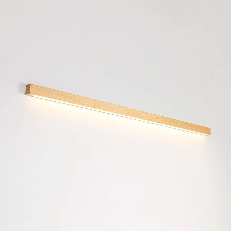 Walnut coloured linear wood and acrylic LED strip wall lamp mounted on a wall.