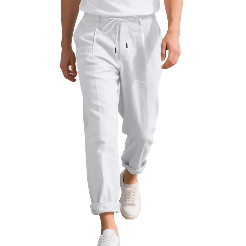 Men's light khaki linen casual trousers with a straight leg and drawstring waistband laid flat.