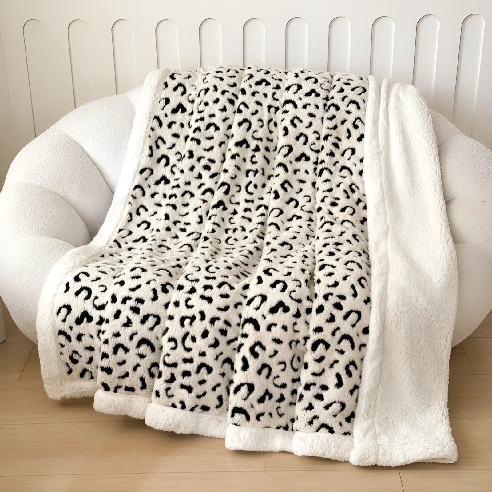 Double-layer leopard jacquard taffeta blanket in camel zebra pattern on a single bed.
