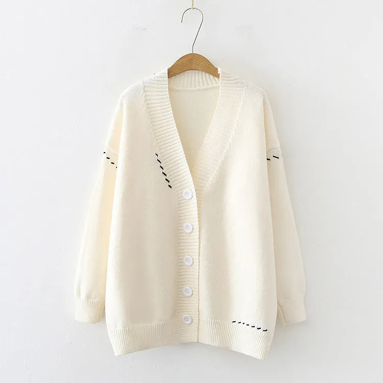 Women's loose fit black knitted cardigan coat with long sleeves.