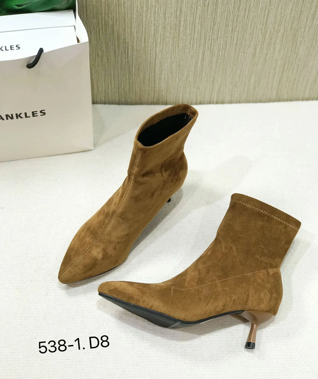 Women's black pointed toe ankle boots with a stiletto heel and mid-calf sock length.