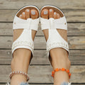 A pair of slope heel Roman style slippers with a fish mouth toe holder, shown in one of six available colours.